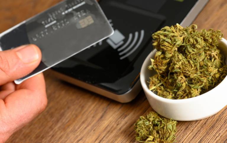 tapping your card on a dispensary to buy a gram of weed